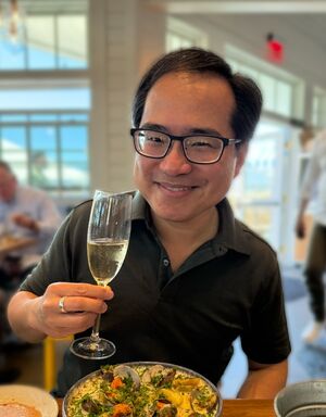 Andrew toasting with a glass of champagne
