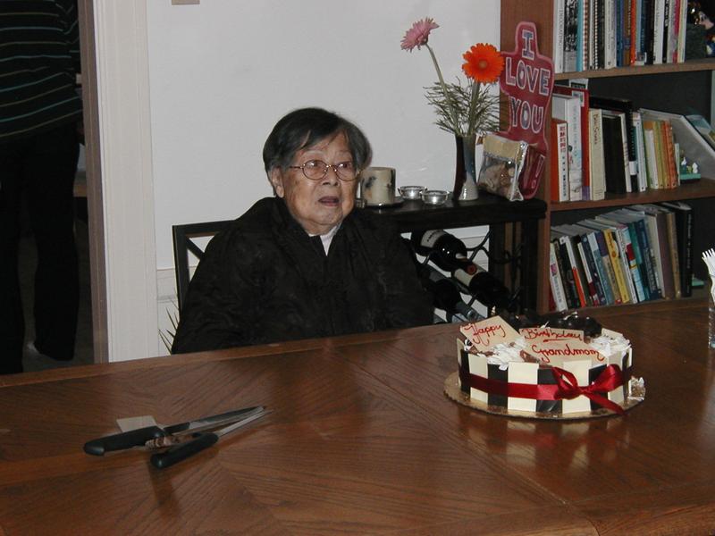 Closeup of grandmother and cake