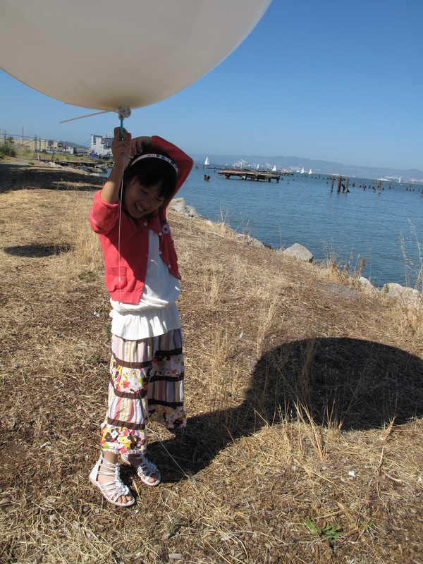 Sum holding the balloon. She is probably 5% lighter with the help of the balloon.