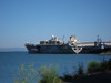 The mysterious carrier that turned out to be the ex-USS Tripoli, as seen from Warm Water Cove Park.
