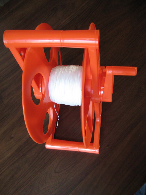 The cord reel, loaded with 1,000 feet of kite line.