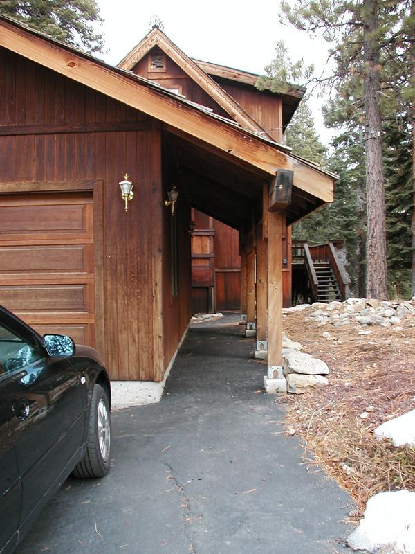To the right of the garage, the walkway leading to the front door